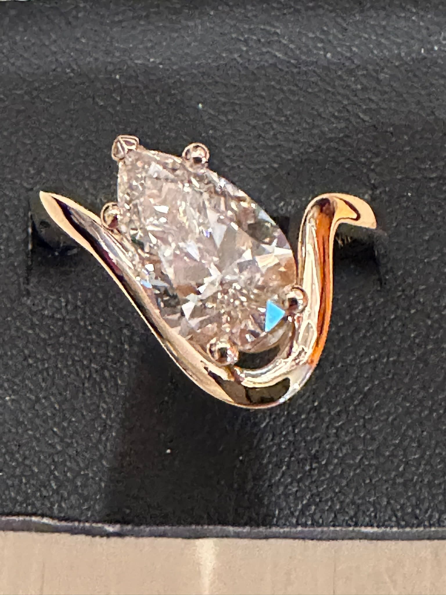 Pear-cut diamond ring with a sweeping rose gold setting